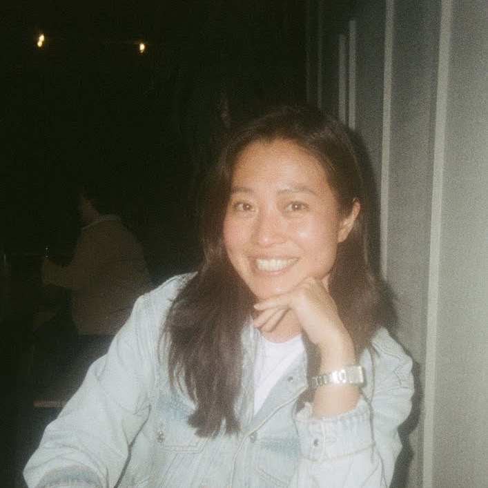 Angela Wu Li smiling in a denim jacket